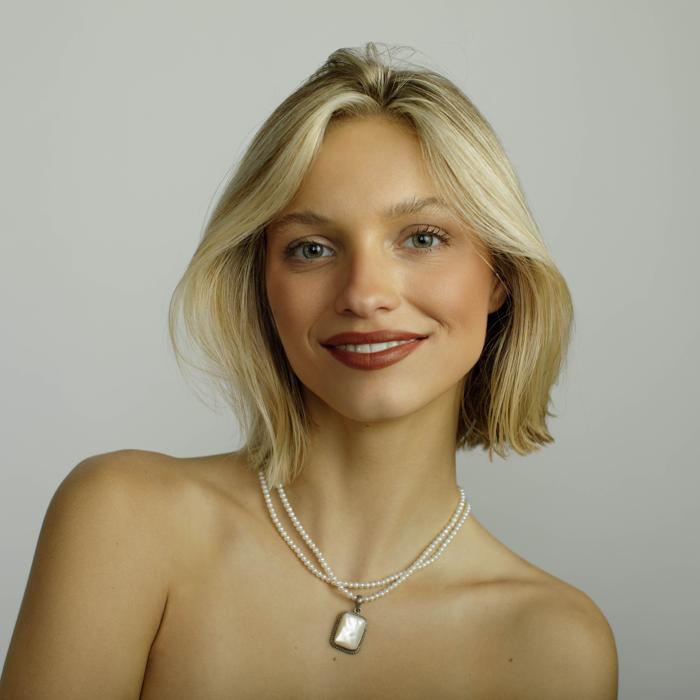 Caucasian female model displaying jewelry brand by photographer Marty Gottlieb